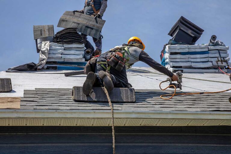 Roof inspector examining crooked shingles and damaged flashing on a residential roof.